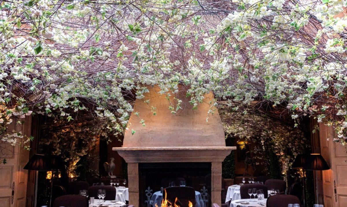 The beautiful flower-filled interior of Clos Maggiore in Central London